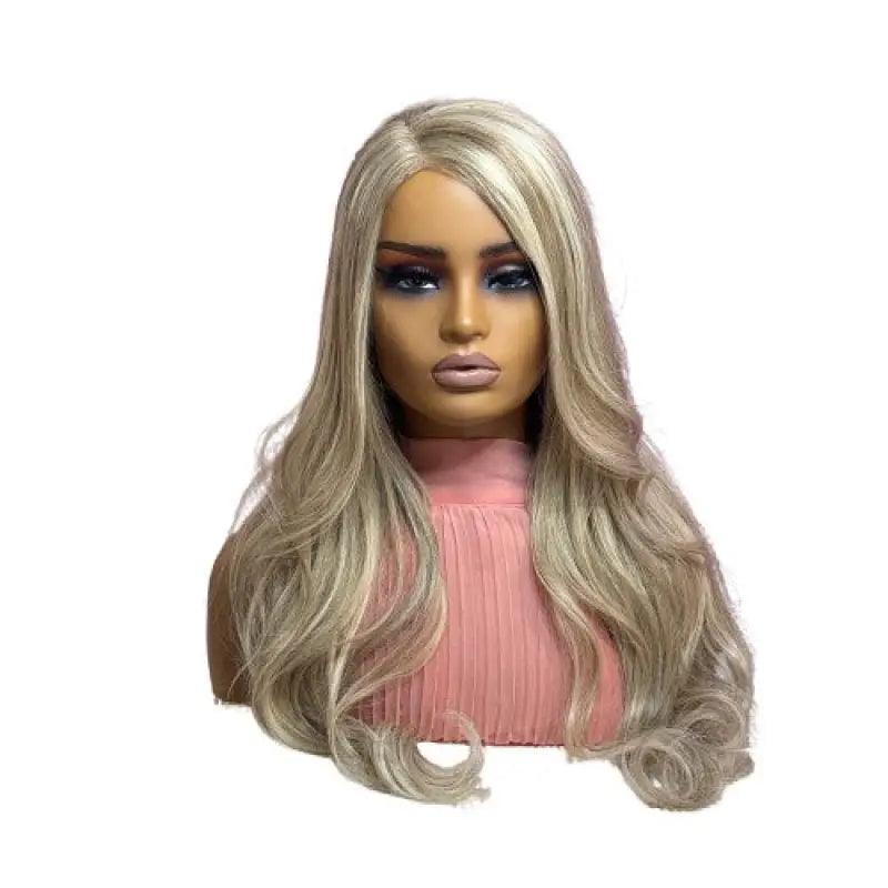 Mannequin head with blonde wig wearing a pink sweater against a pink and white striped background.